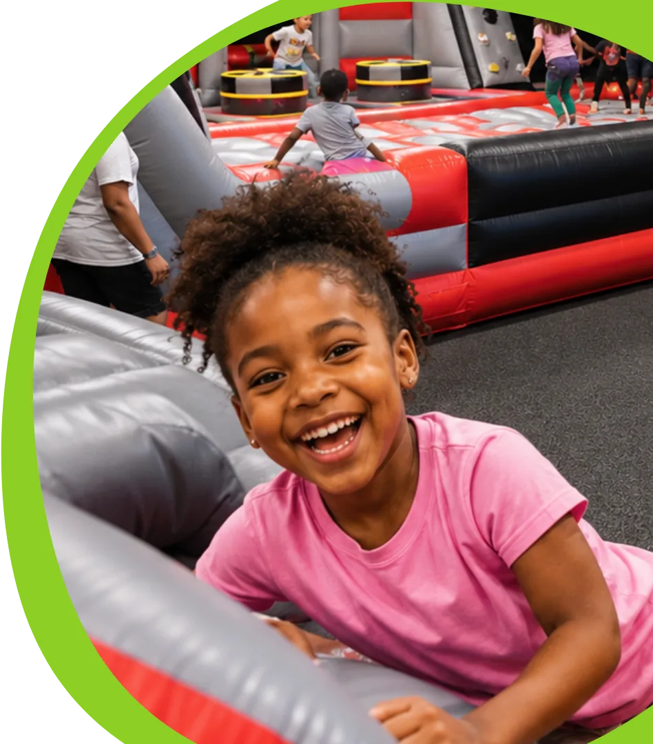 Happy child playing in the inflatable park